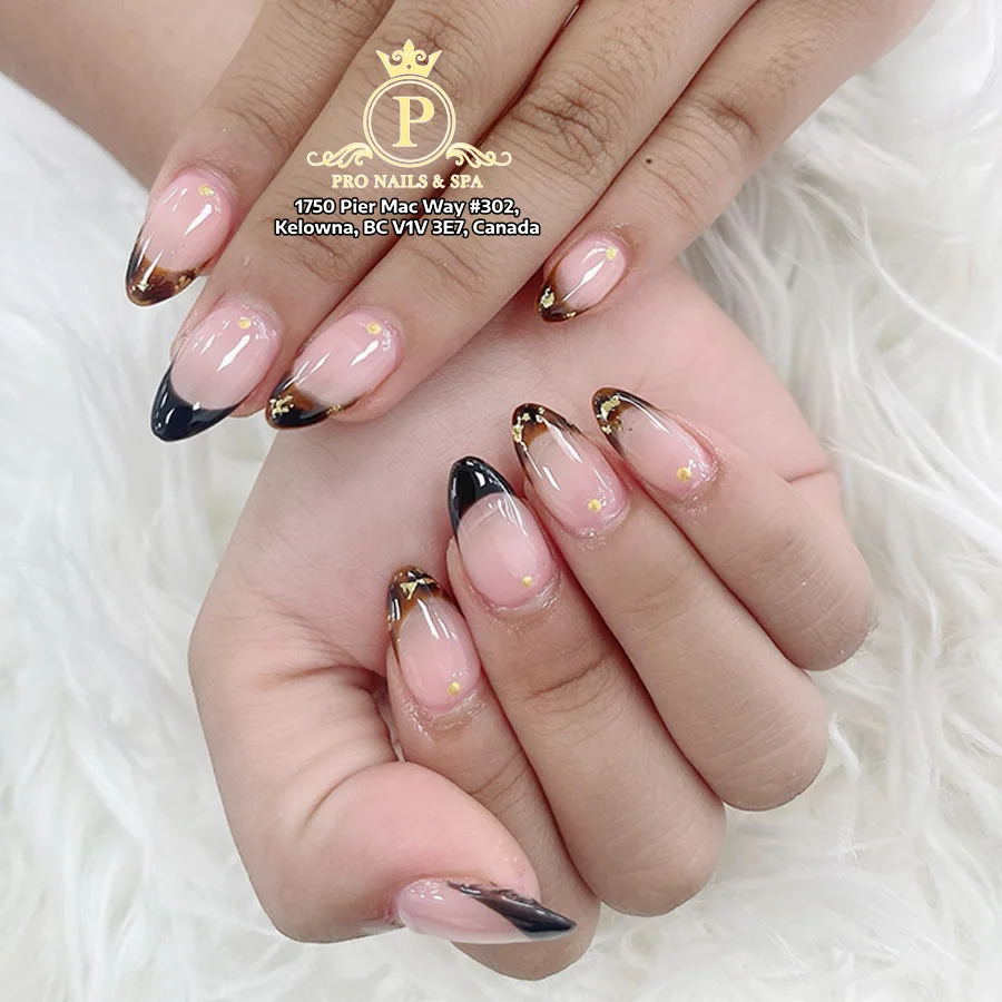 Rosy pink and black French nails with gold accents